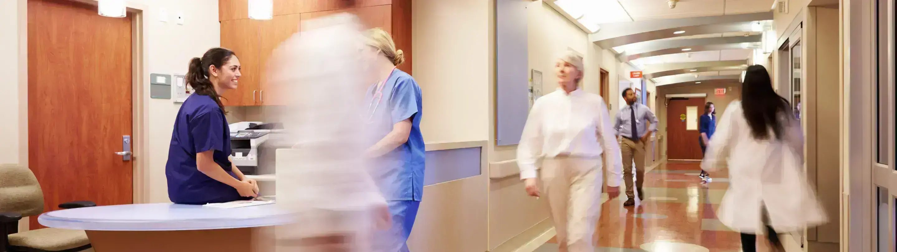 Doctors in motion in hospital hallway