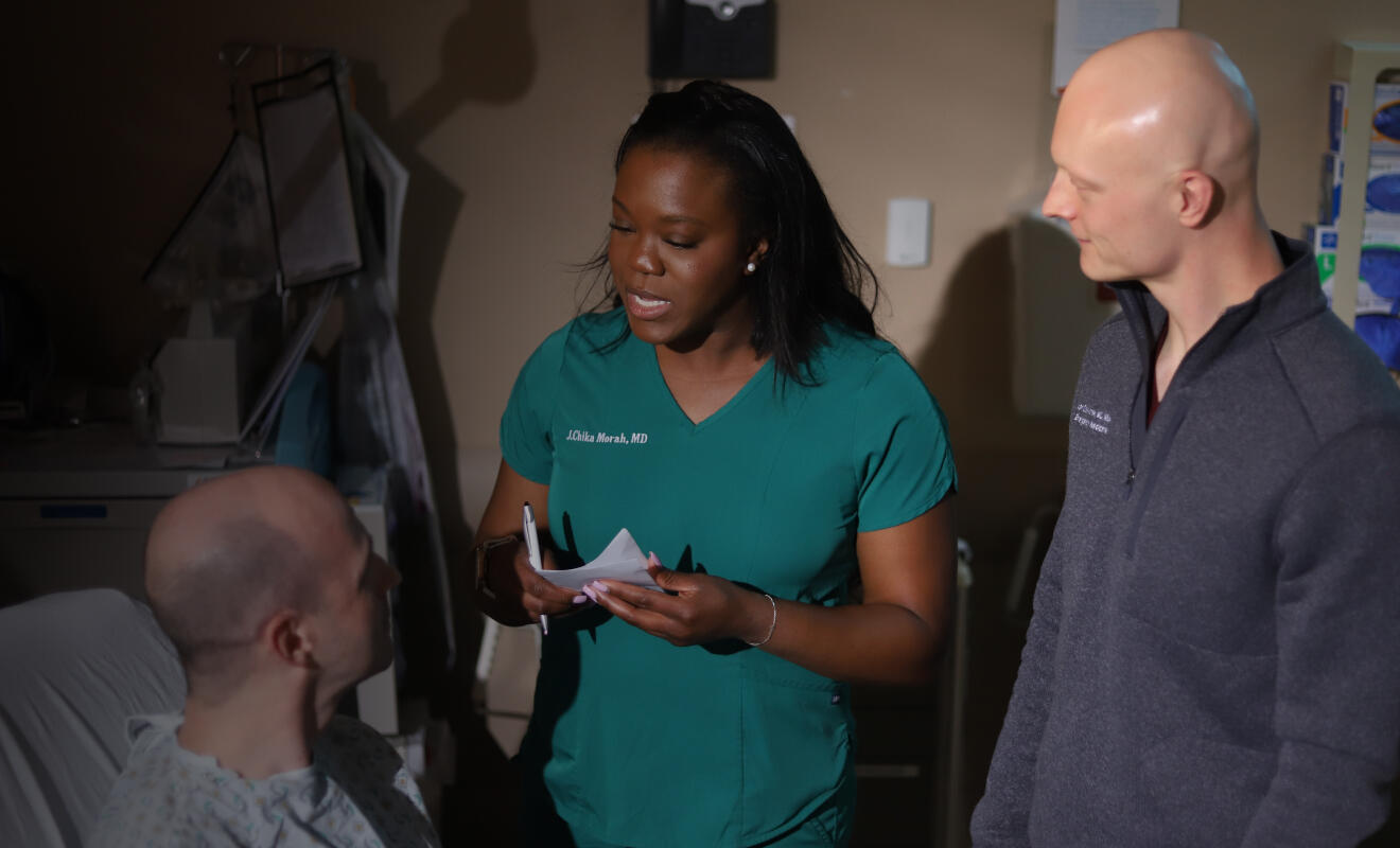 Two doctors talking to a patient