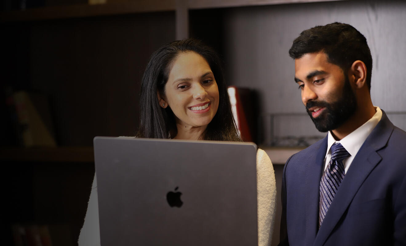Two USACS employees using a laptop