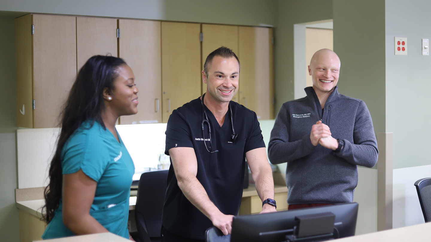 3 Health system leaders smiling and talking