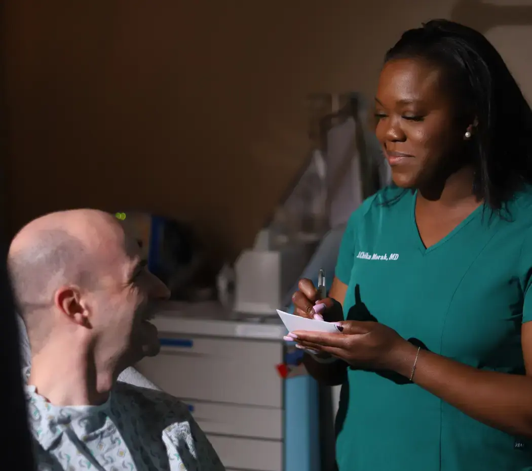 Clinician talking to patient while taking notes