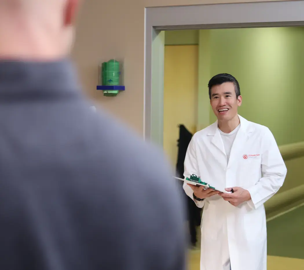 Doctor smiling at a patient getting discharged from the hospital