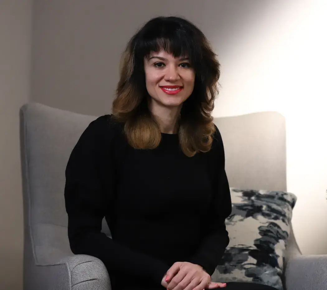 Clinician woman, smiling in a chair