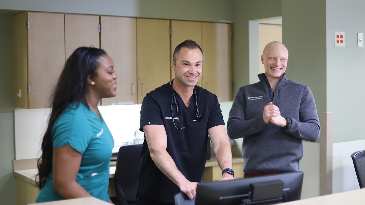 3 Health system leaders smiling and talking