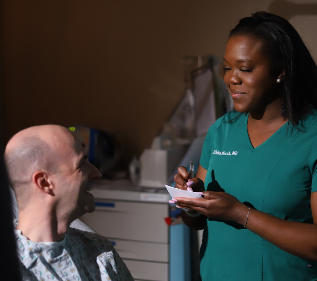 doctor standing beside a patient's bed